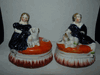 PAIR ANTIQUE STAFFORDSHIRE GIRL AND BOY SITTING WITH DOGS INKWELLS PAIR ANTIQUE STAFFORDSHIRE GIRL AND BOY SITTING WITH DOGS INKWELLS