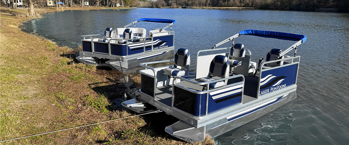 A Laker Pontoon boat on a calm lake at sunset