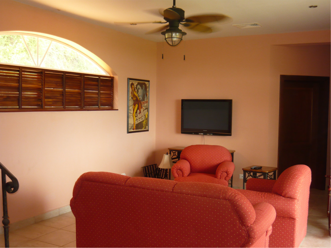 Fully furnished living room with flat-screen TV.