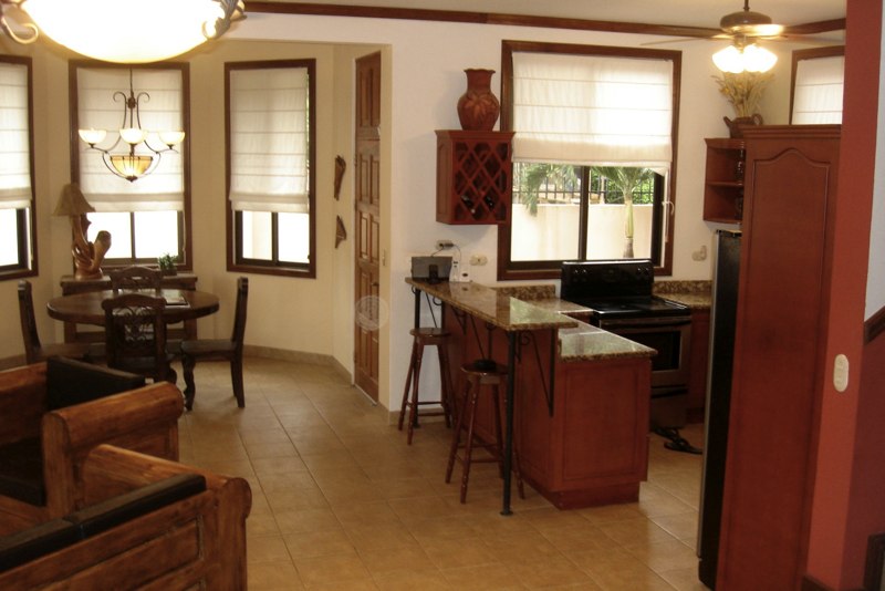 Living room, breakfast nook and kitchen completely surrounded by windows.
