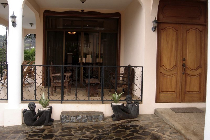 Villa�s entrance adjacent to the wrap-around porch and outdoor seating nook.
