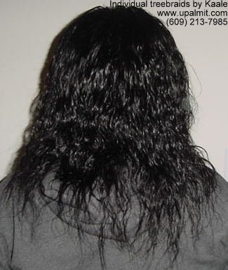 Individual treebraids with wet and wavy human hair, back view.