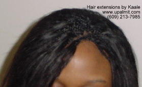 Hair extensions, hair weave with microbraids in front.