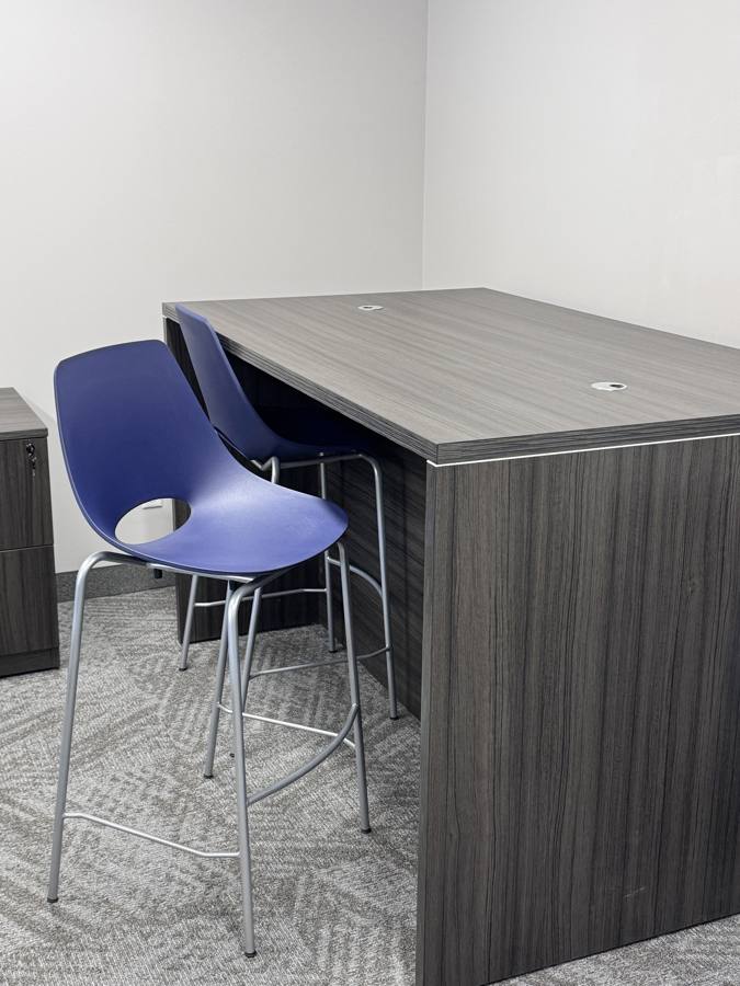 Standing-height table with stools on the showroom floor