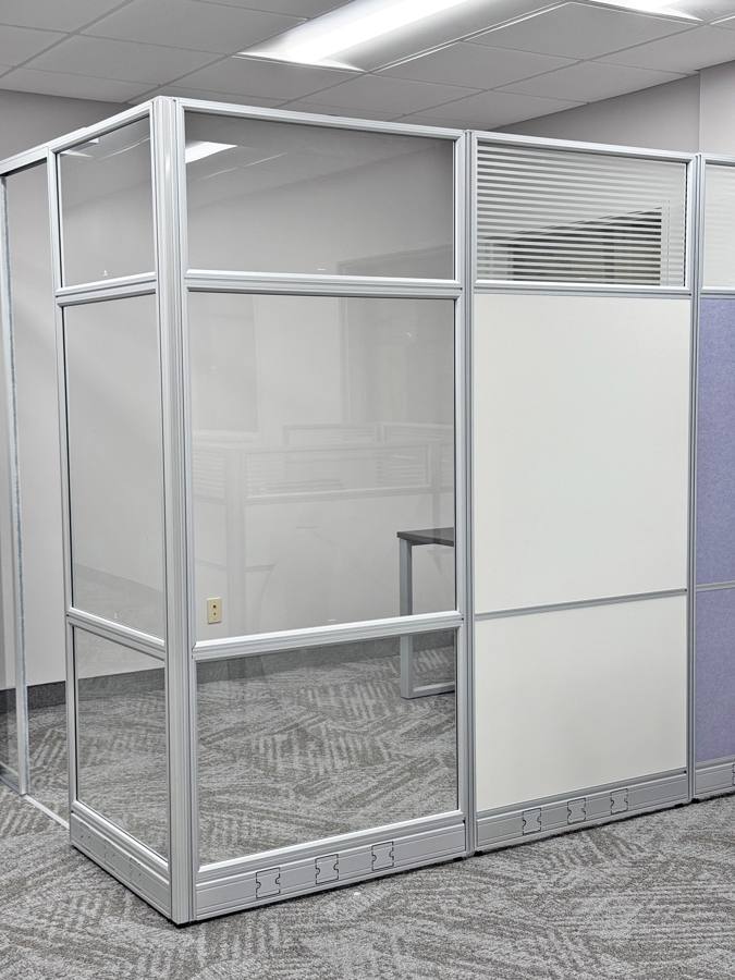 Glass office enclosure with panel walls in the showroom