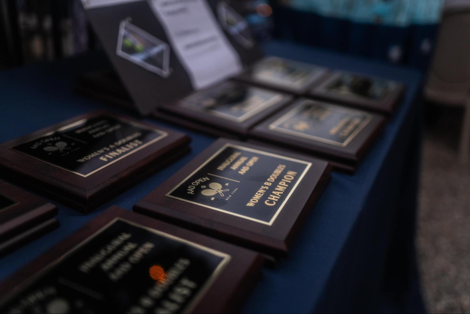 tennis tournament award plaques on a table