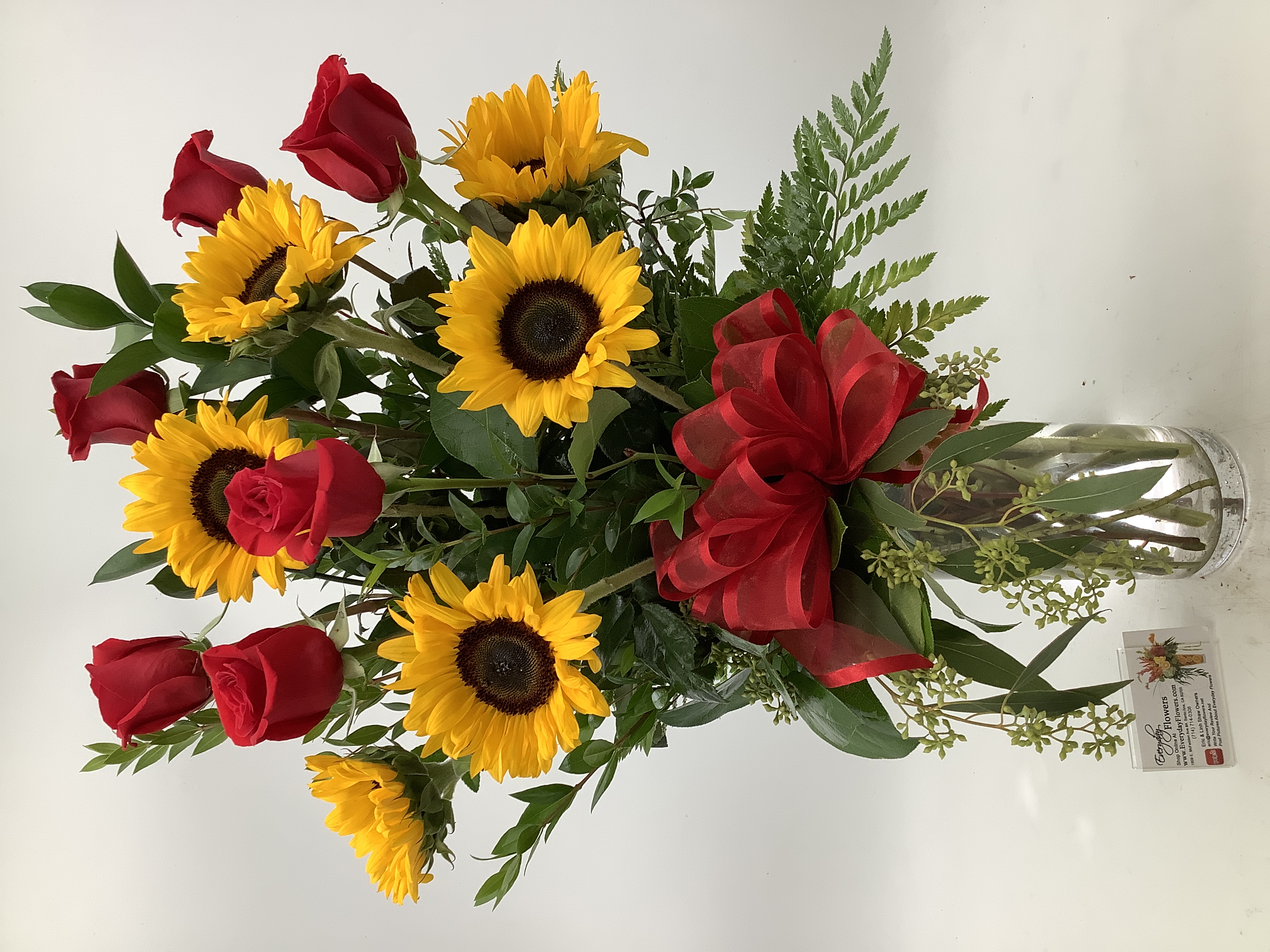 Red roses and sunflowers designed by Everyday Flowers in Santa Ana