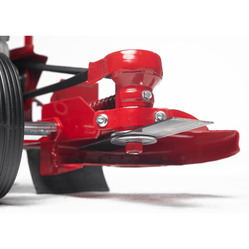 Underside perspective of the edger head, showing the blade mounting and debris clearance path.