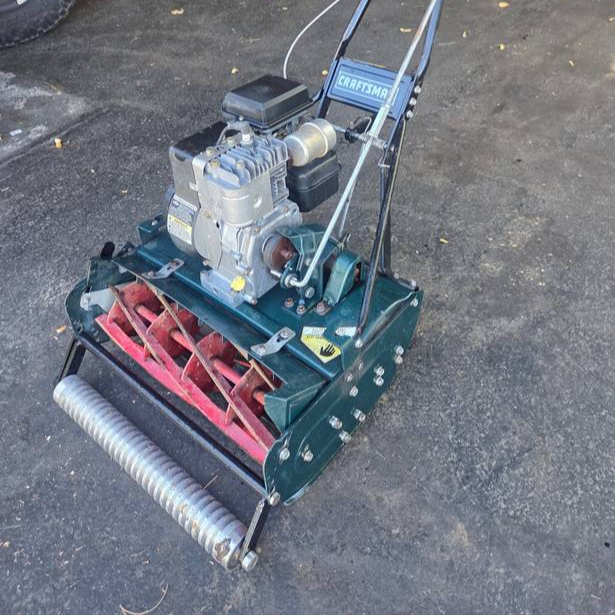Vintage Craftsman 7-Blade Reel Mower manufactured by McLane, featuring a grooved front roller.