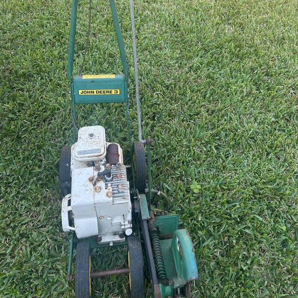 A vintage edger with white label branding from John Deere made by McLane