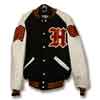 This is a simple yet beautiful letter jacket with black wool body and white leather sleeves. An old-english letter is on the front along with an embroidered name. The sleeves of the letterman jacket have a class of chenille patch and a chenille chevron patch.
